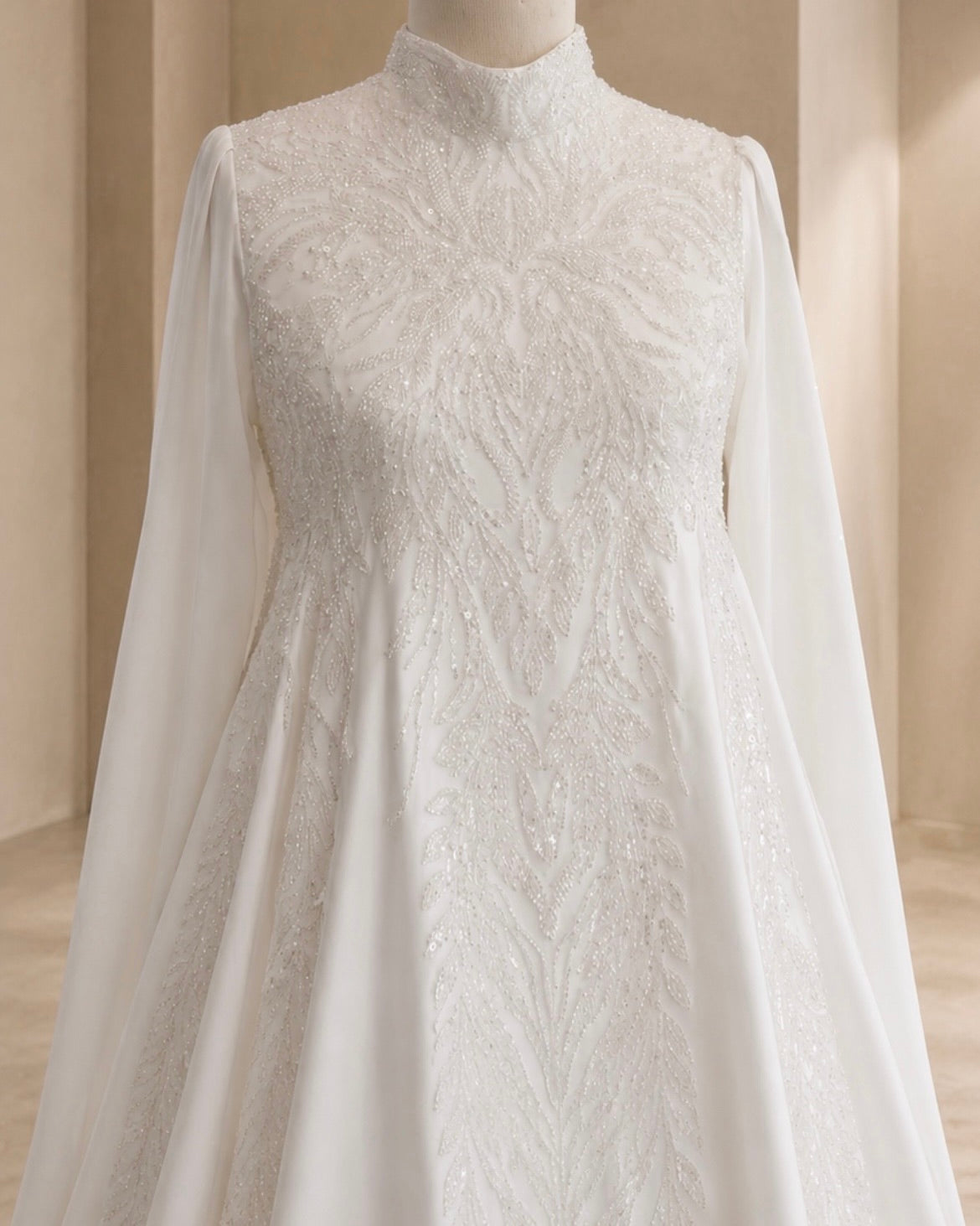White lace dress on a mannequin against a neutral background