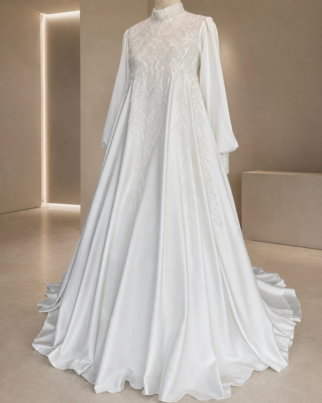 White lace wedding dress with long sleeves on a neutral background