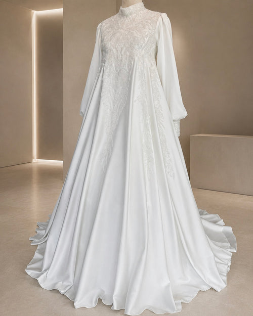 White lace wedding dress with long sleeves on a neutral background